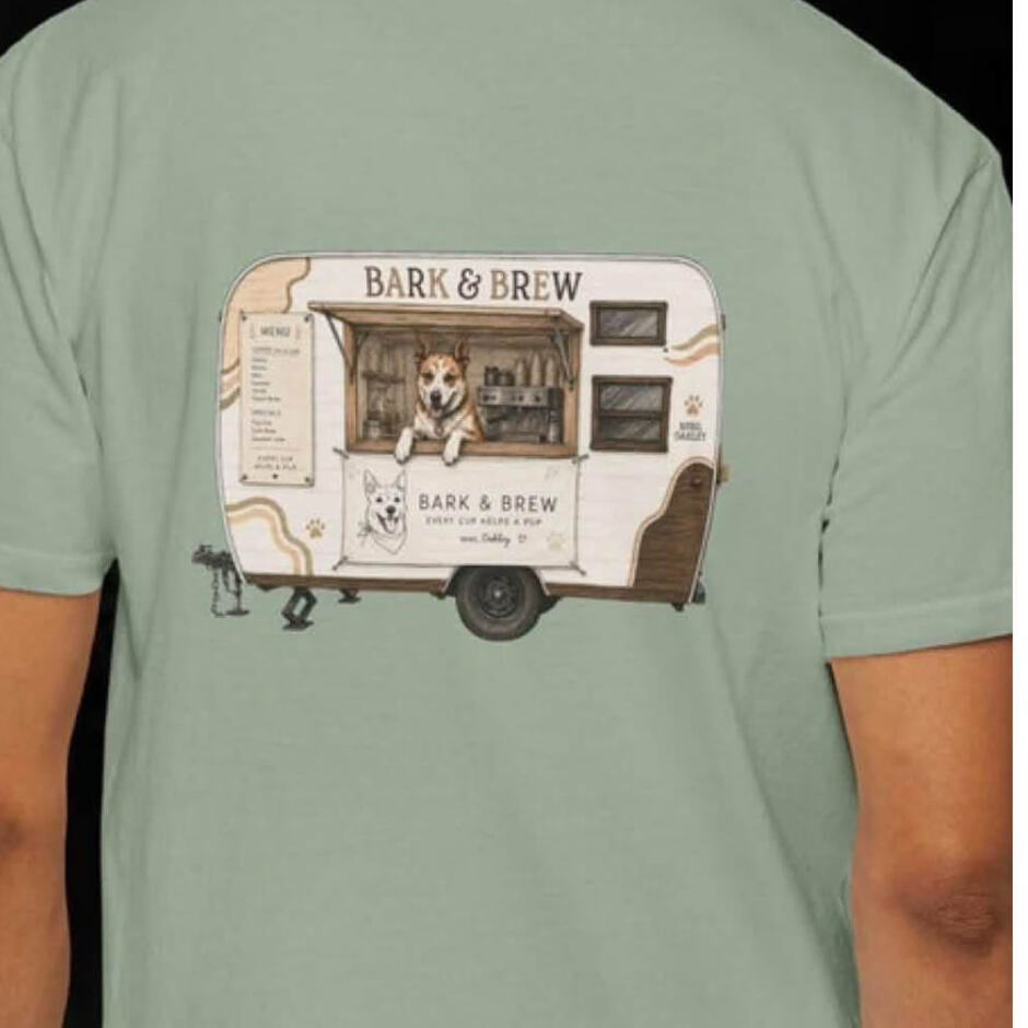 Sage green t-shirt with Bark & Brew trailer artwork on the back and a small chest print