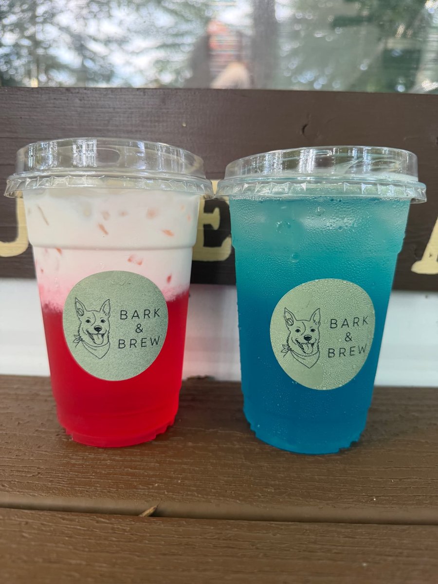 Two Bark & Brew cold drinks sitting on a wooden ledge outdoors