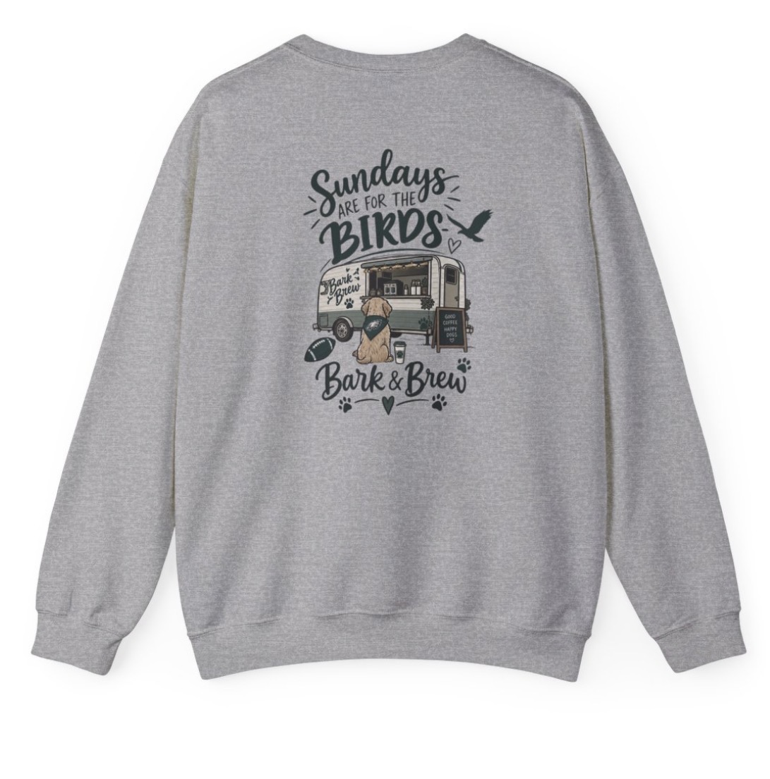 Grey sweatshirt printed with “Sundays are for the birds” and a gold retriever pup in an Eagles bandana by the Bark & Brew trailer